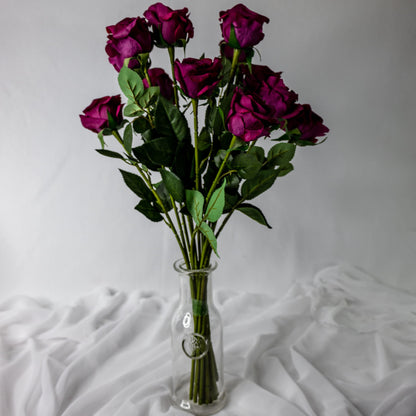 artificial cranberry roses placed in clear glass vase