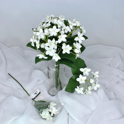 artificial Stephanotis placed in glass transparent glass