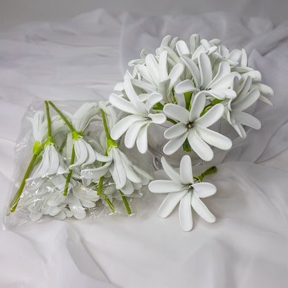 artificial tahitian gardenia flowers placed in transparent glass vase