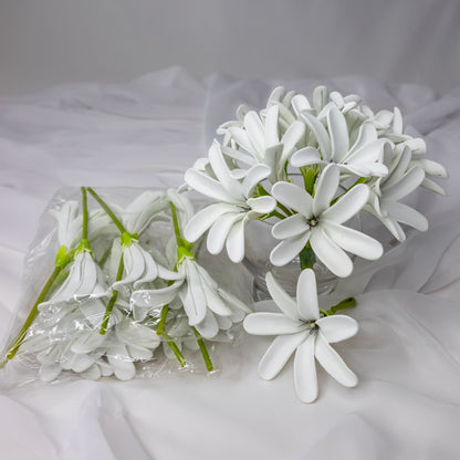 artificial tahitian gardenia flowers placed in transparent glass vase