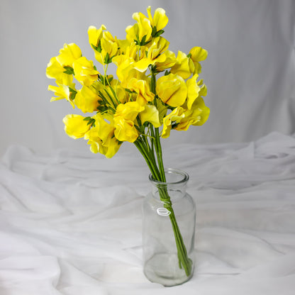 artificial yellow sweet pea in glass vase