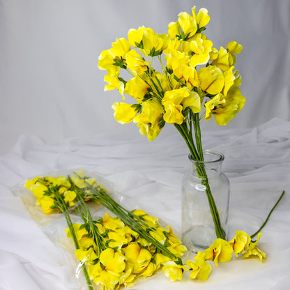 artificial yellow sweet pea in glass vase