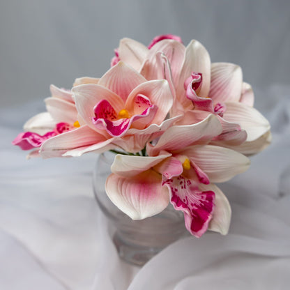 Artificial Pink Cymbidium in clear glass vase