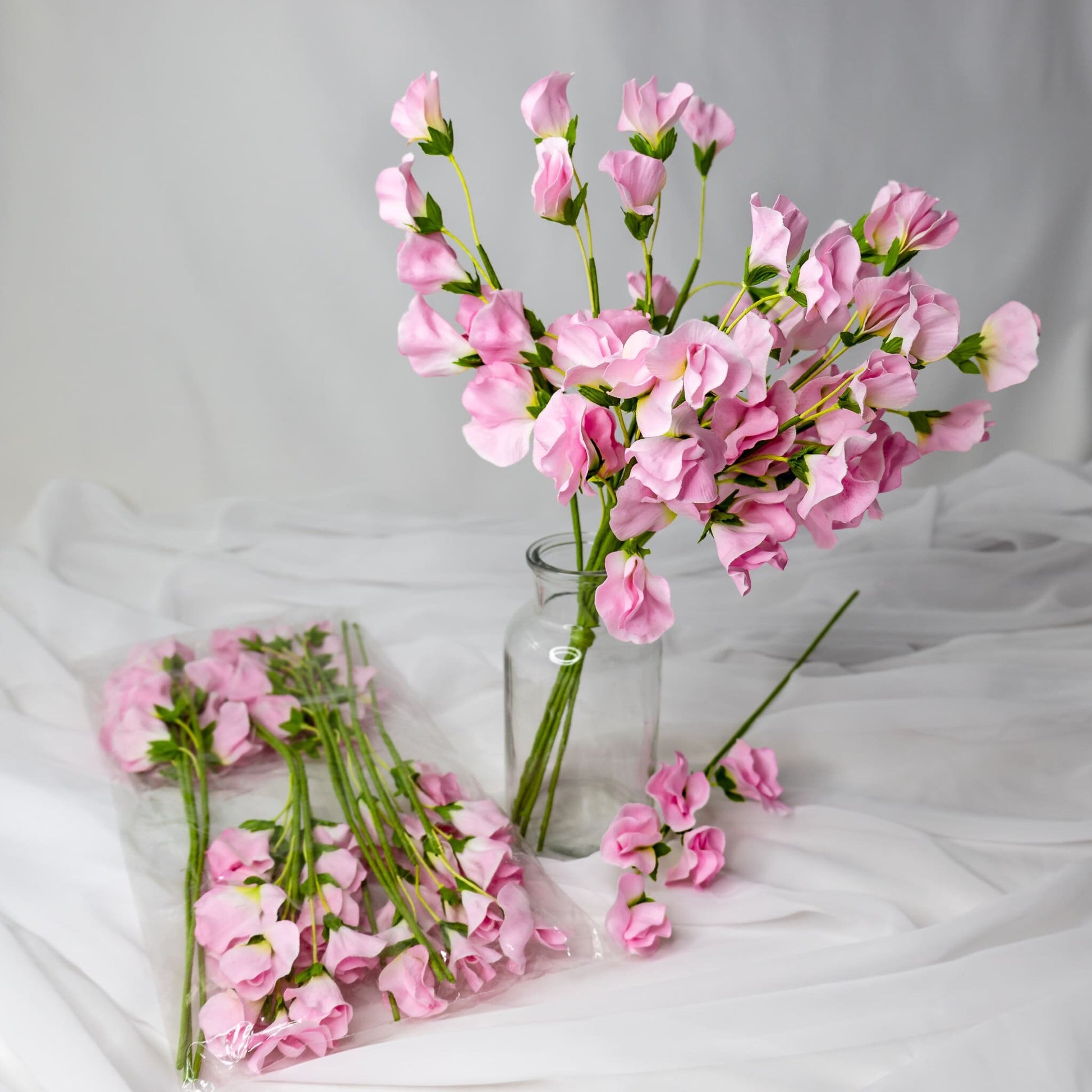 artificial Pink Sweet Peas in clear glass vase