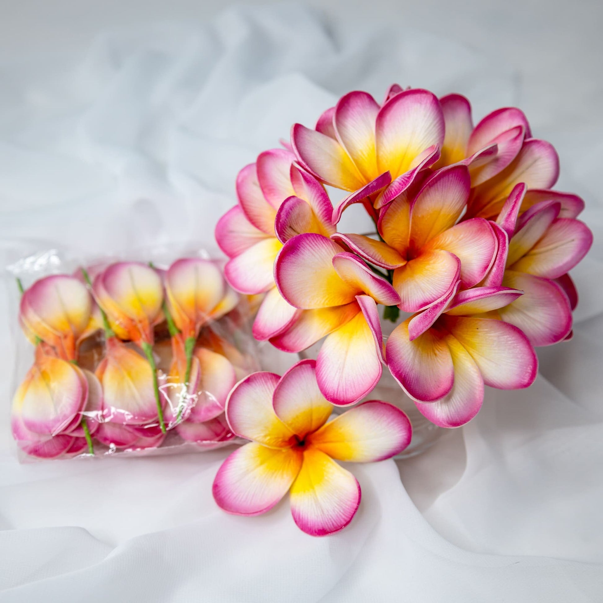 artificial Sunset Pink Frangipani Flowerheads in clear vase