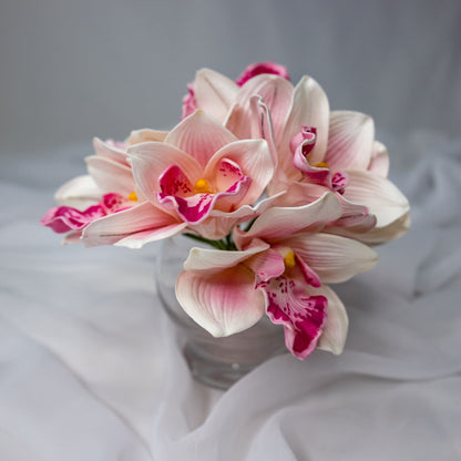 Artificial Pink Cymbidium in clear glass vase