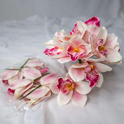 Artificial Pink Cymbidium in clear glass vase