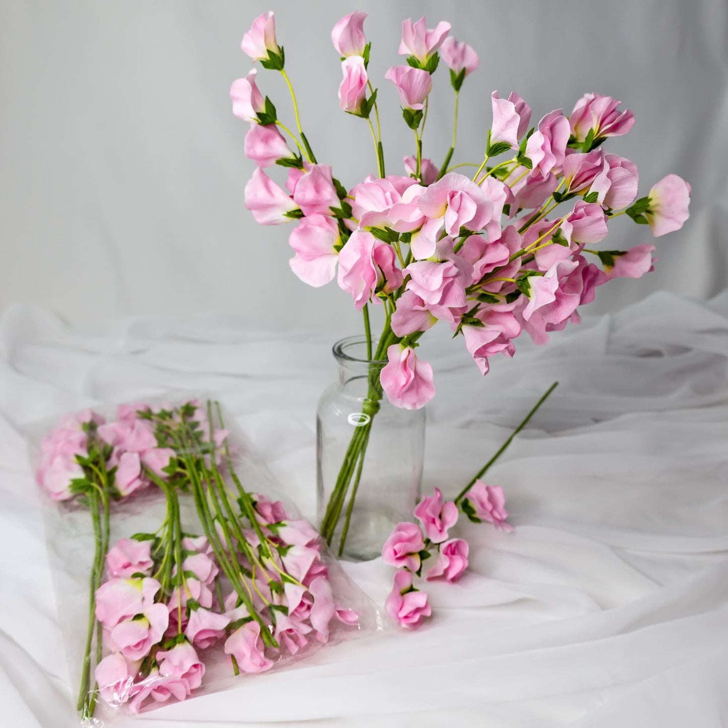 artificial Pink Sweet Peas in clear glass vase