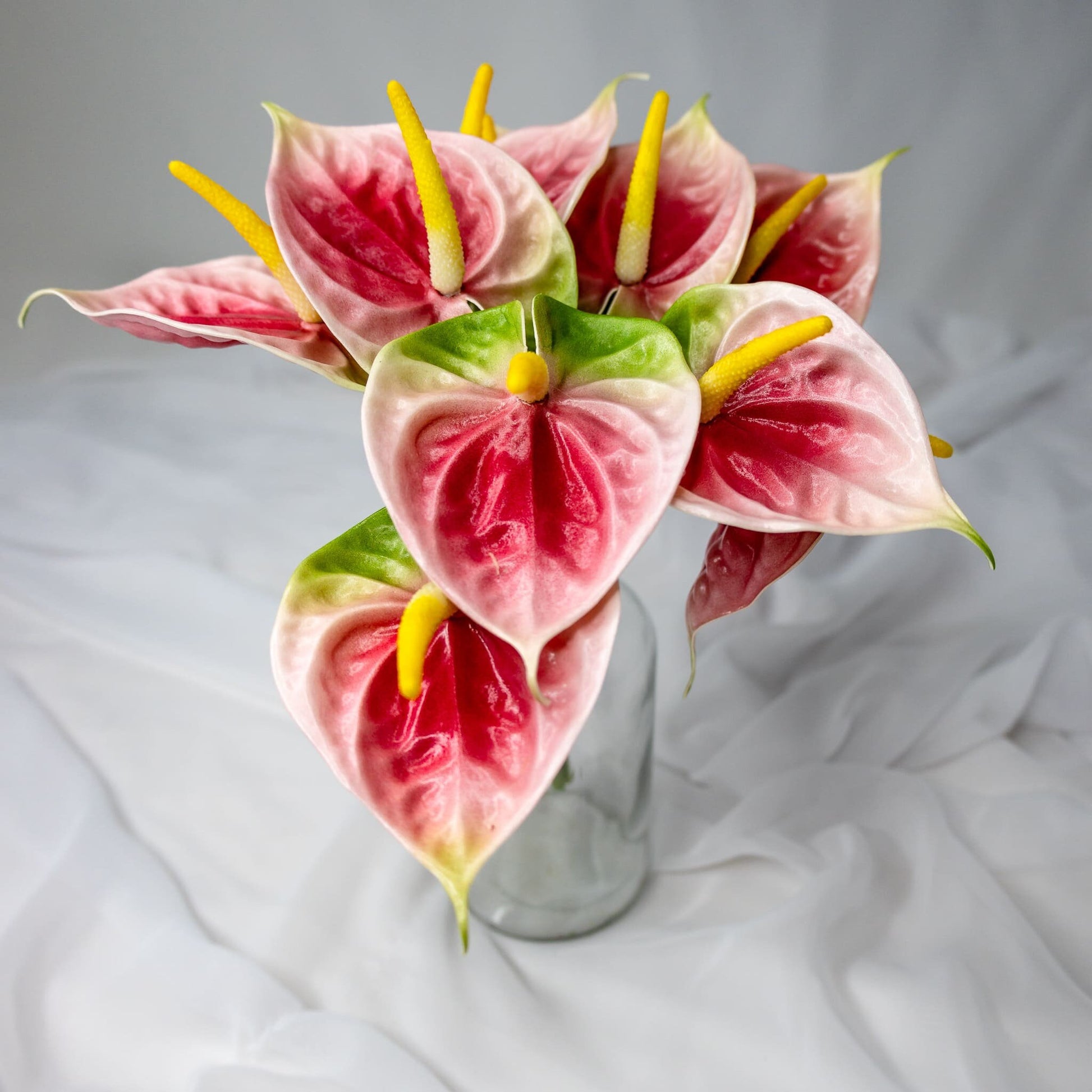 artificial Pink/Green Small Anthuriums in clear glass vase