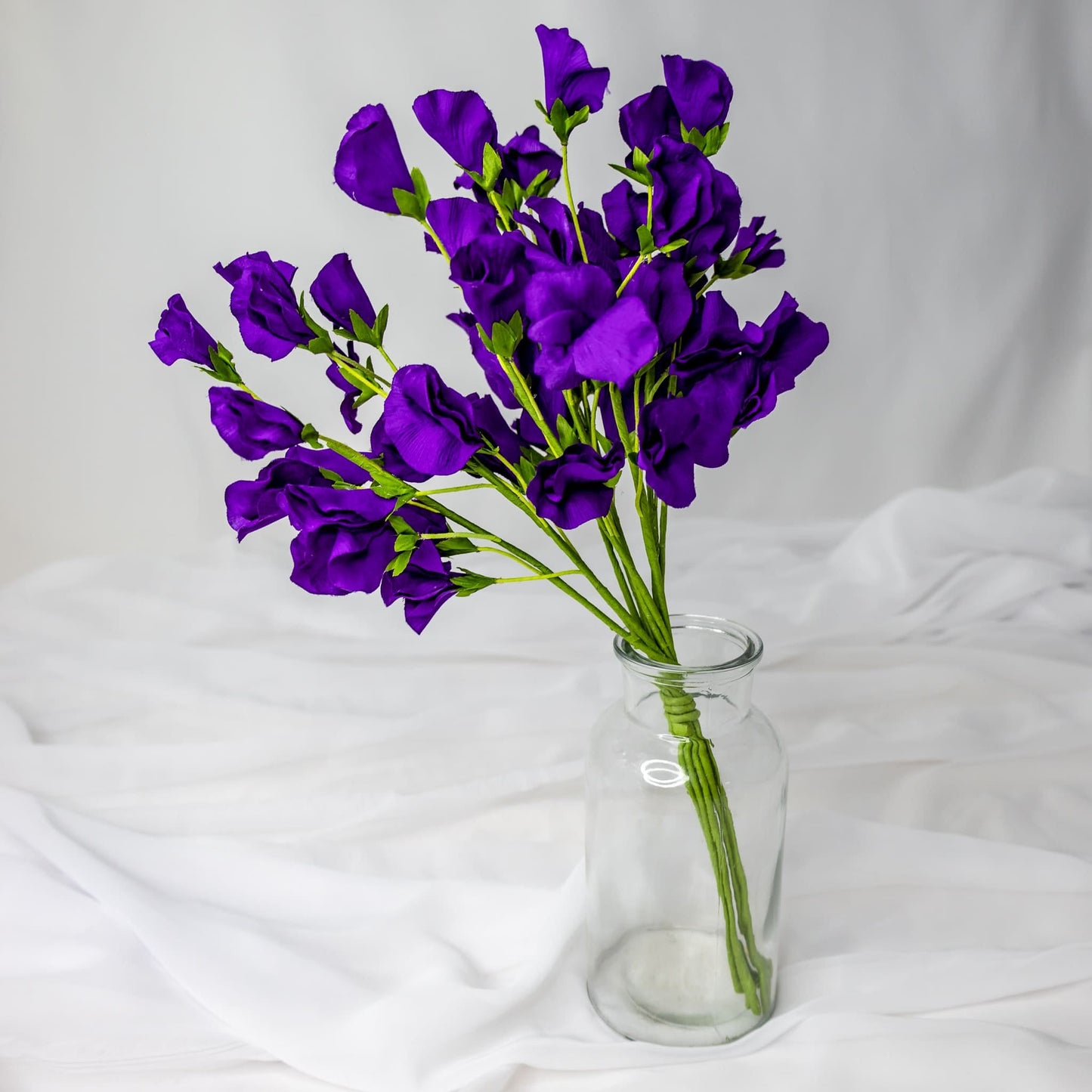 artificial Purple Sweet Pea in clear glass vase