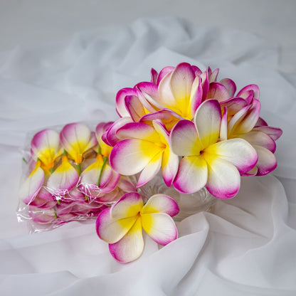 artificial white fuchsia frangipani flowerhead in clear glass vase