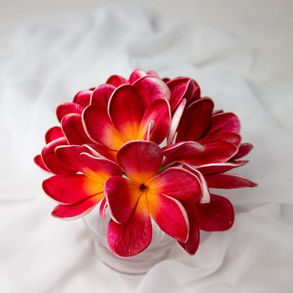 artificial passion frangipani flowers in transparent glass vase