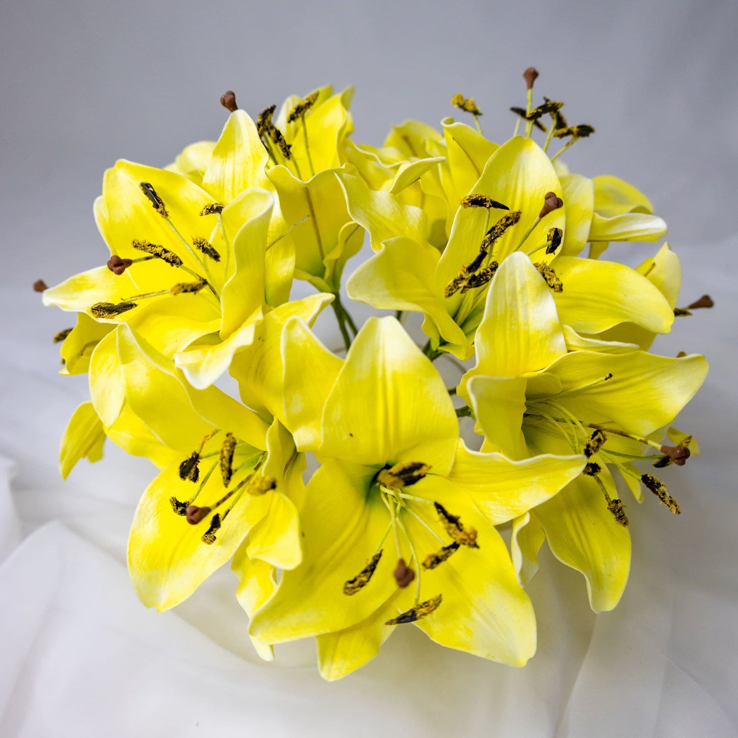 artificial Yellow Asiatic Lily Flowerhead in clear glass vase top vase