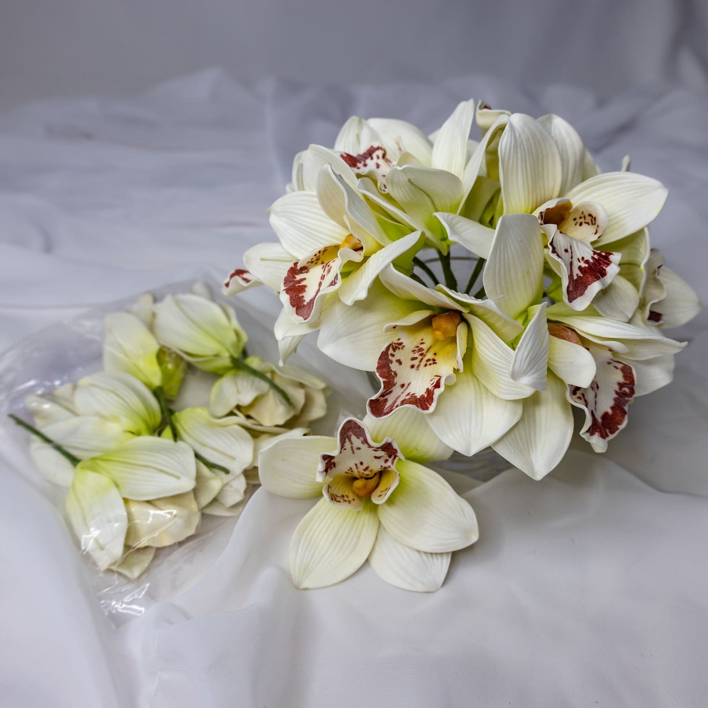 artificial White/Burgundy Cymbidium in clear glass vase