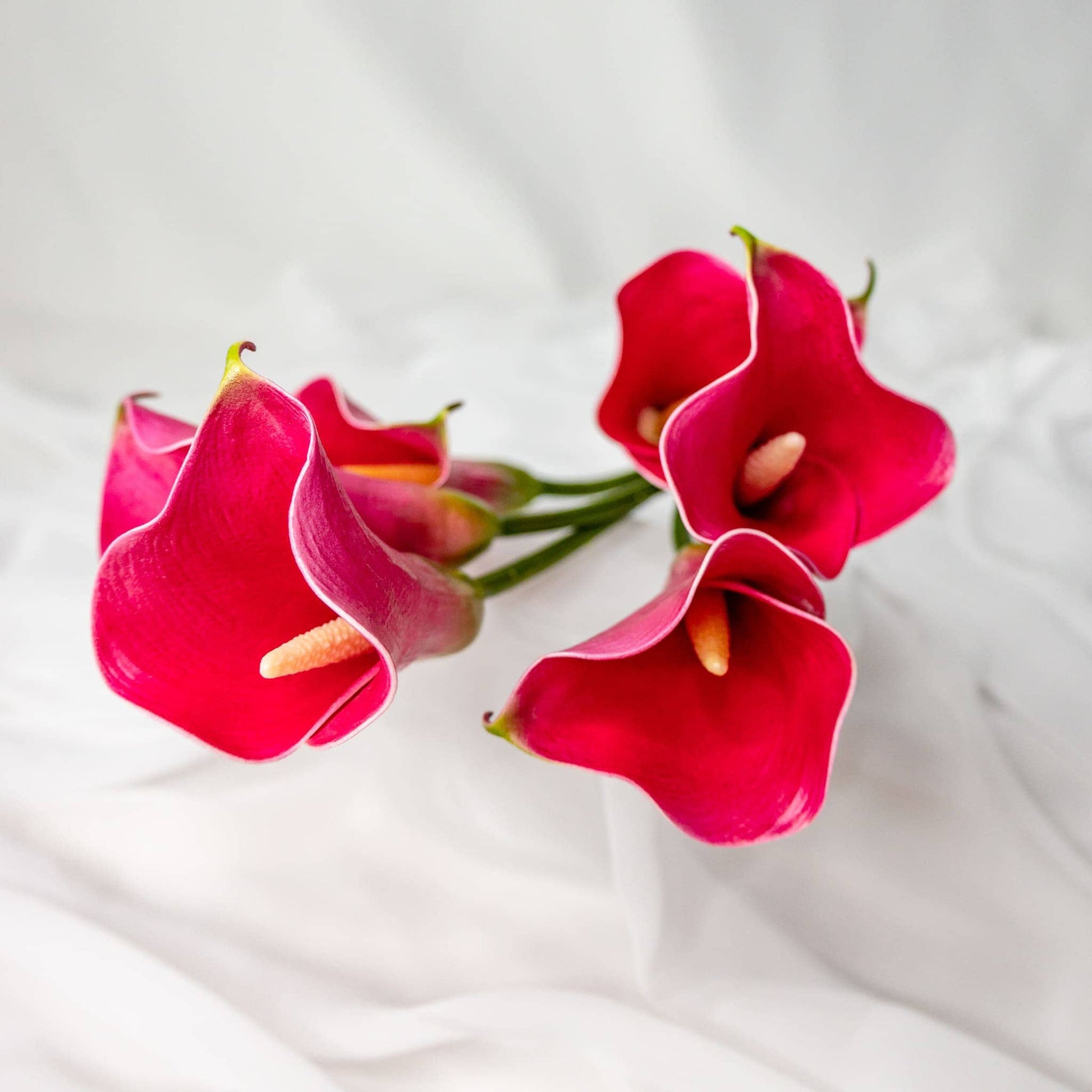 artificial fuchsia small calla lilies top view