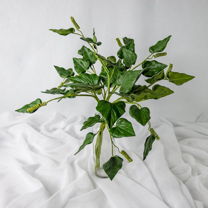 artificial trailing heart vine placed in transparent glass vase