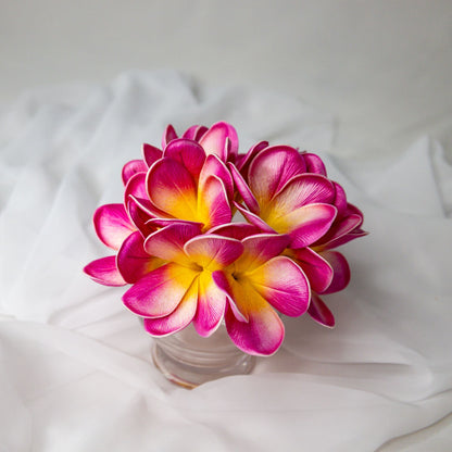 artificial pink frangipani orchids place in glass vase